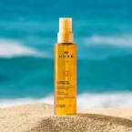 ⁦زيت نوكس صن المسرع للتسمير بحماية عالية للوجه والجسم بعطر استوائي ساحر - 150 مل⁩ - الصورة ⁦2⁩